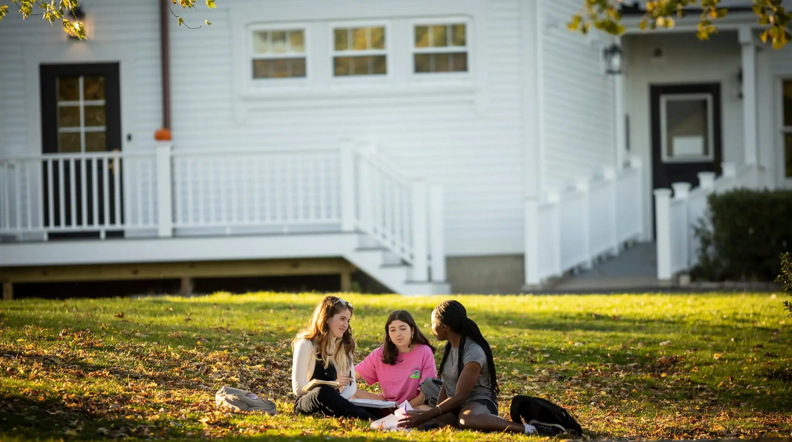 Three girls studying outside.